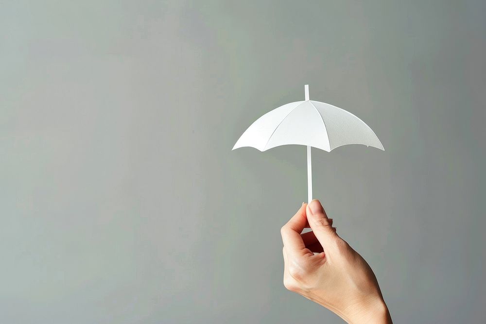 A umbrella paper cut model holding hand protection.