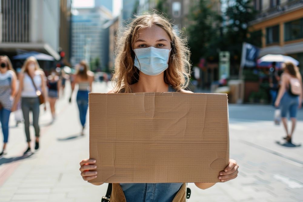White woman wear mask cardboard accessories pedestrian.