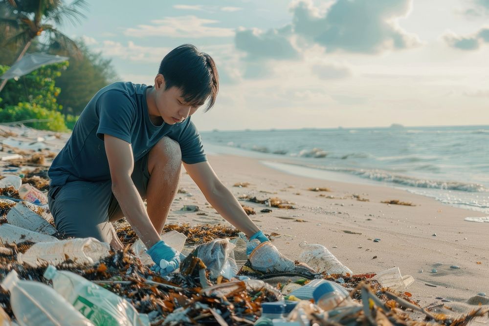 Asian man volunteering garbage beachwear clothing.