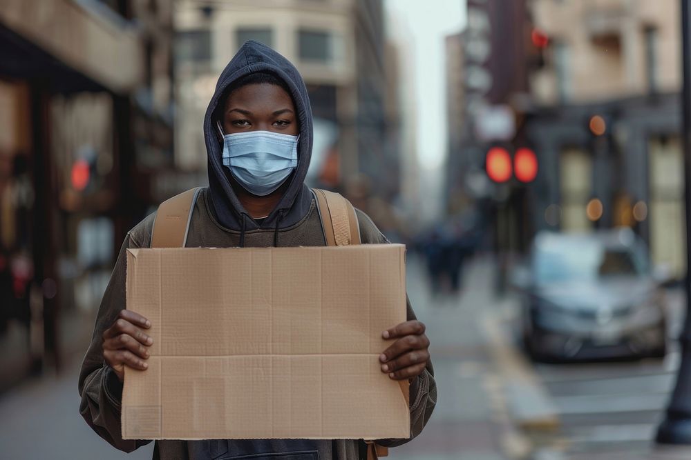 Black teenager wear mask cardboard transportation accessories.