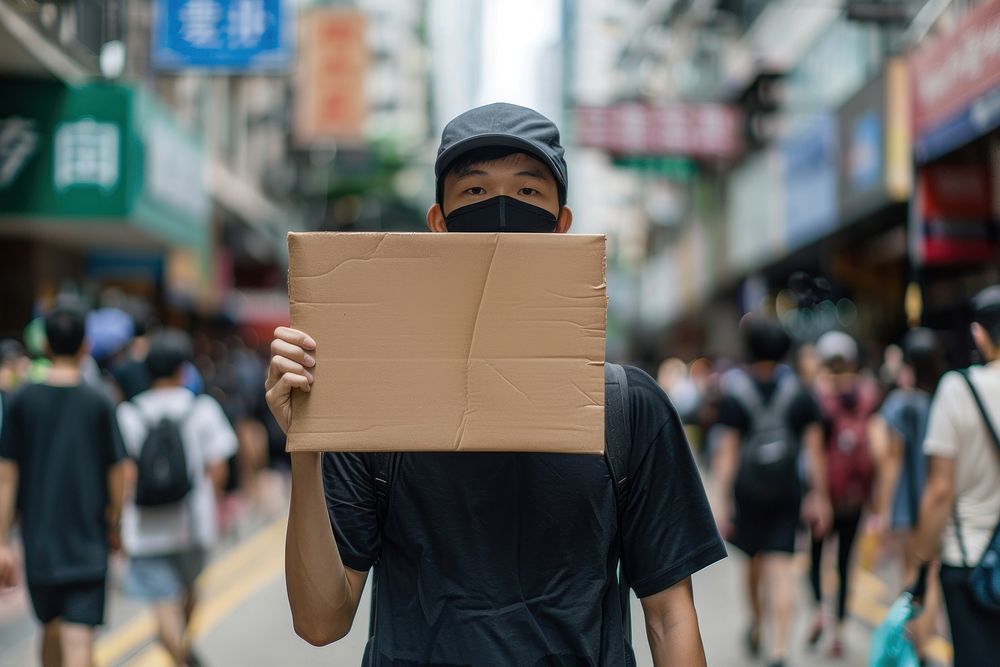 South east asian man wear black cardboard accessories pedestrian.