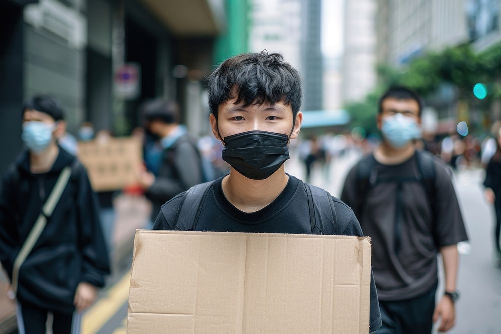 South east asian teenager wear black cardboard package person.