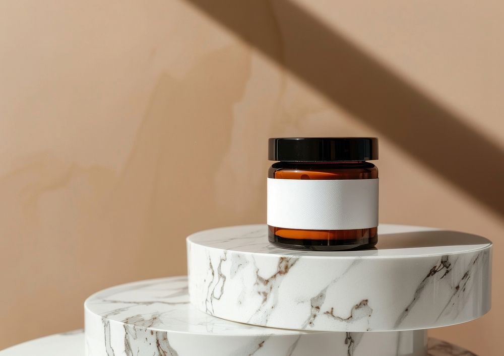 Amber cosmetic jar with white label cosmetics furniture tabletop.