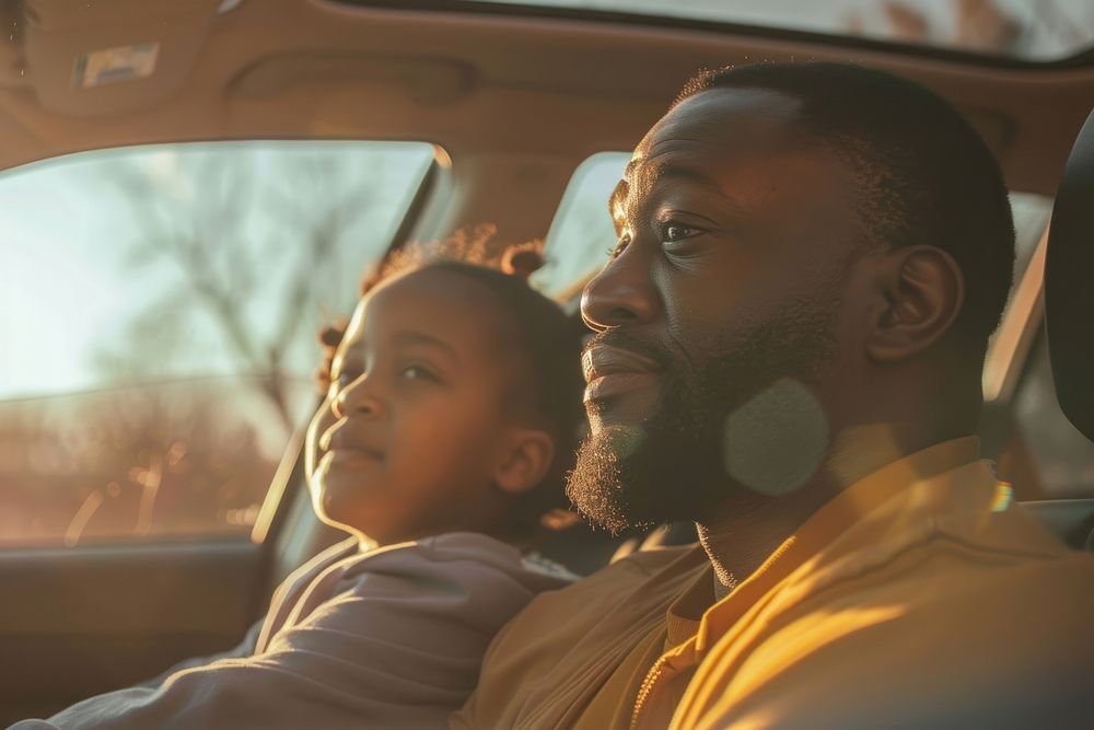 Black dad and daugther behind sitting in car together on the road trip photo transportation photography.