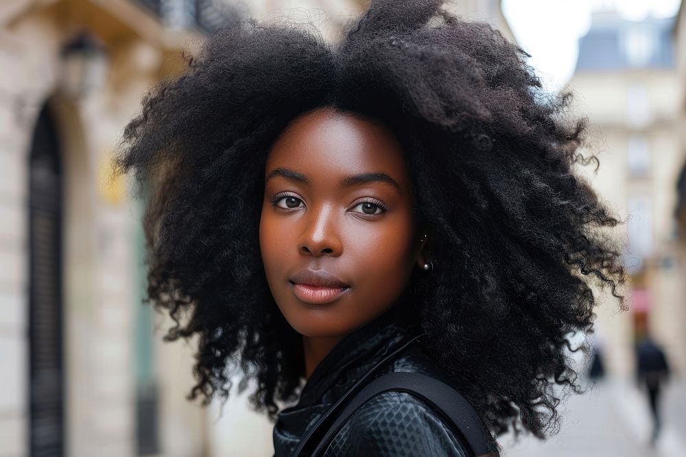 Black woman voluminous layers hairstyles street adult skin.