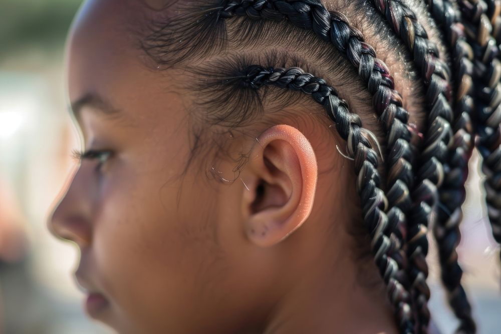 Black woman cornrows braid hairstyles street background contemplation dreadlocks forehead.