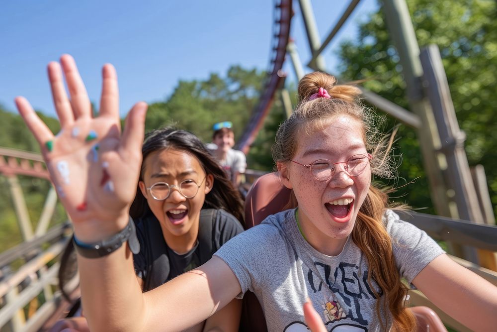 Teenagers on roller coaster adult happy fun.