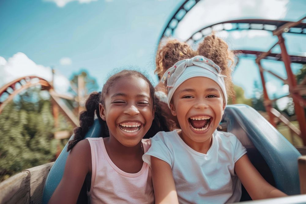Young black girls on roller coaster laughing child happy.