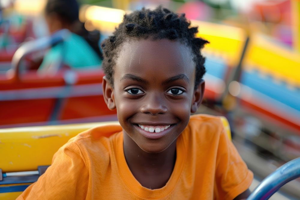 A young black boy on roller coaster child smile happy.