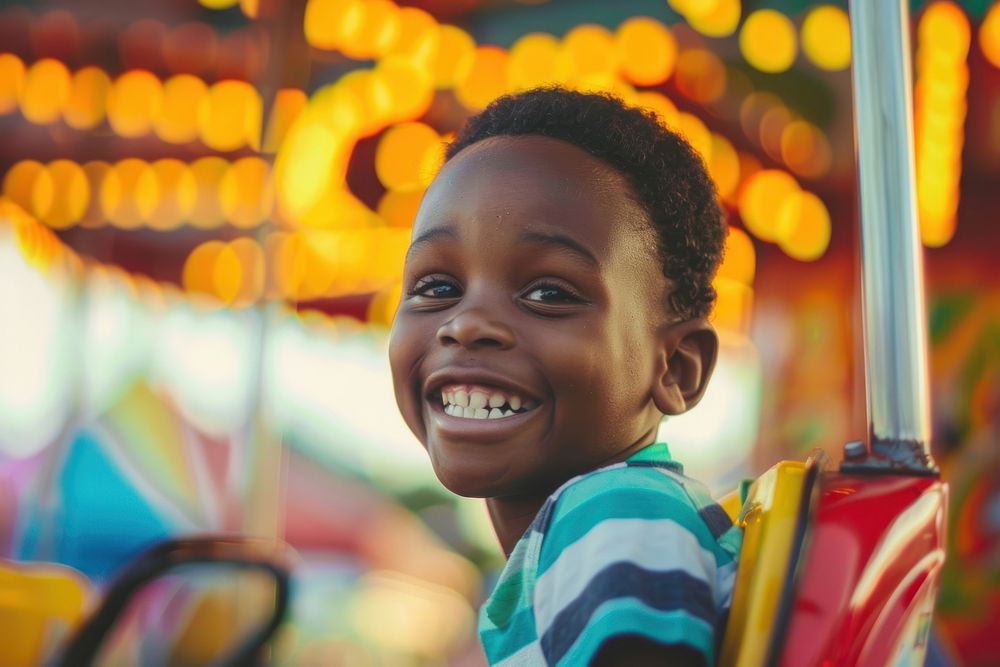 A young black boy on roller coaster portrait smile child.