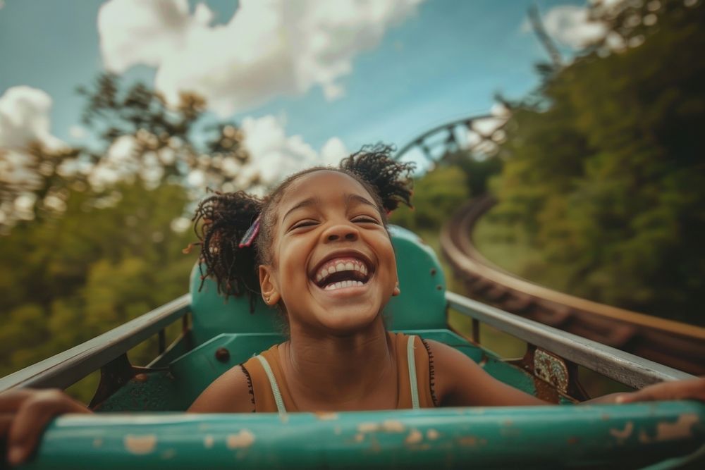 A young black girl on roller coaster laughing happy recreation.