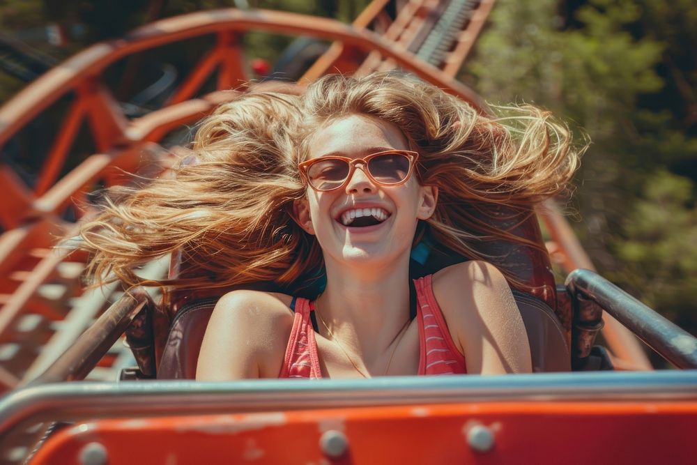 Girl on roller coaster laughing adult happy.