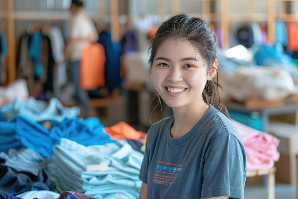 Volunteer packing clothes donation female laundry person.