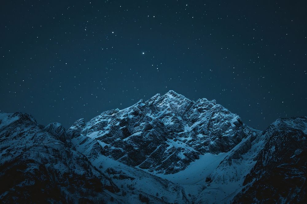 Snowy mountain night sky outdoors.