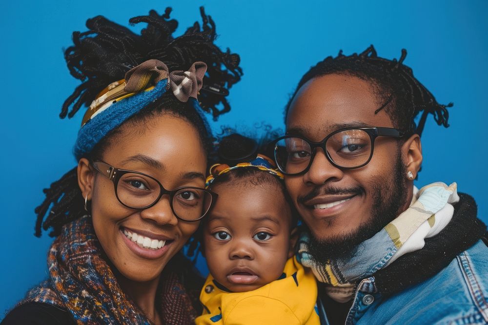 Black couple and baby against happy photo accessories.