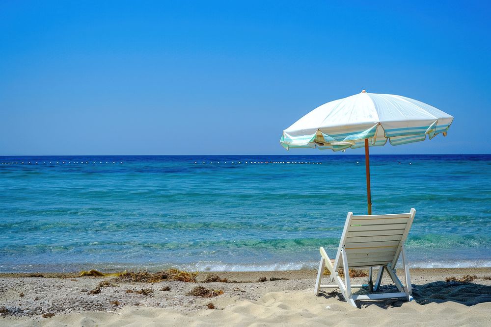 Photo of beach chair sea umbrella outdoors.