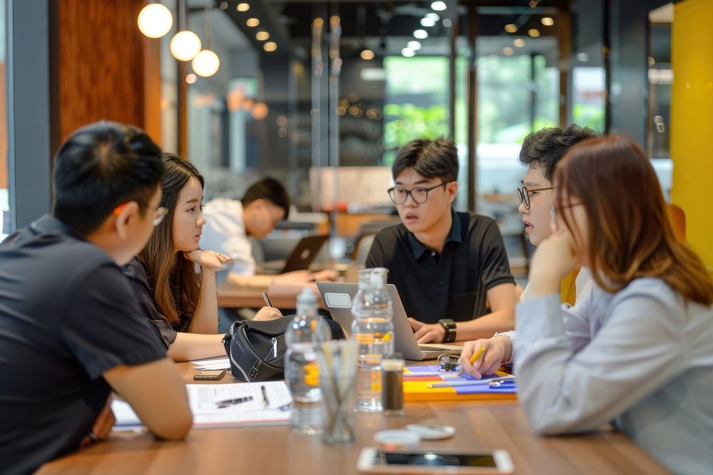 Photo of employee discuss restaurant meeting laptop.