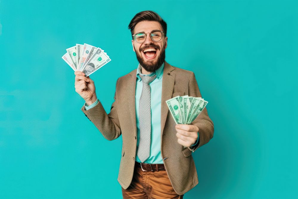 Photo of a happy businessman holding banknotes accessories surprised accessory.