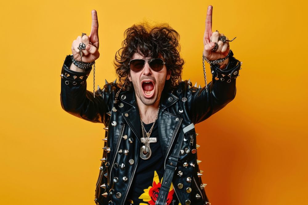 Photo of a rocker man doing rock hand sign pose accessories accessory shouting.