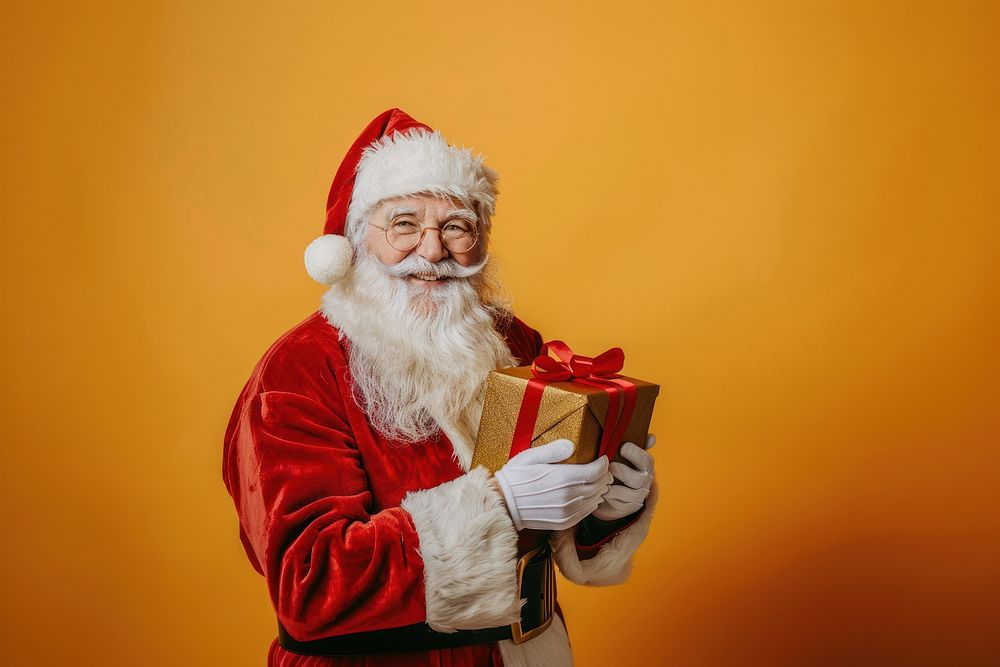 Photo of a santa claus holding a gift box christmas festival clothing.