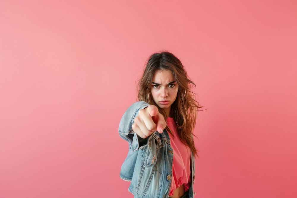 Photo of aggresive female pointing a finger clothing apparel person.