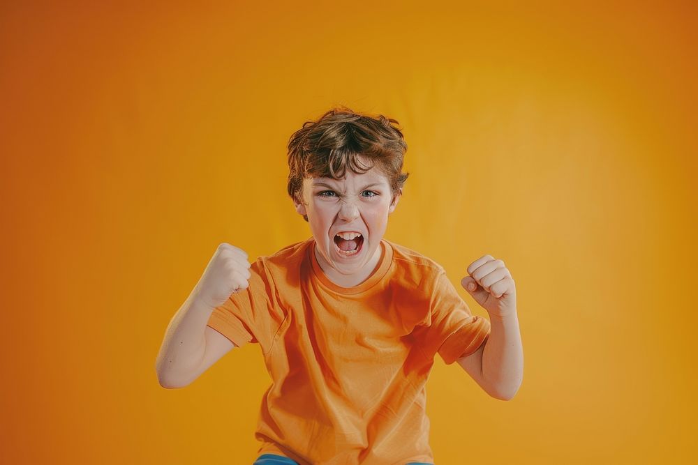 Aggressive kid doing akimbo poses surprised shouting person.