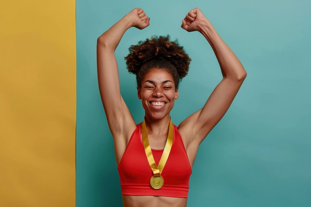 Photo of an black athlete woman raising a gold medal triumphant person female.