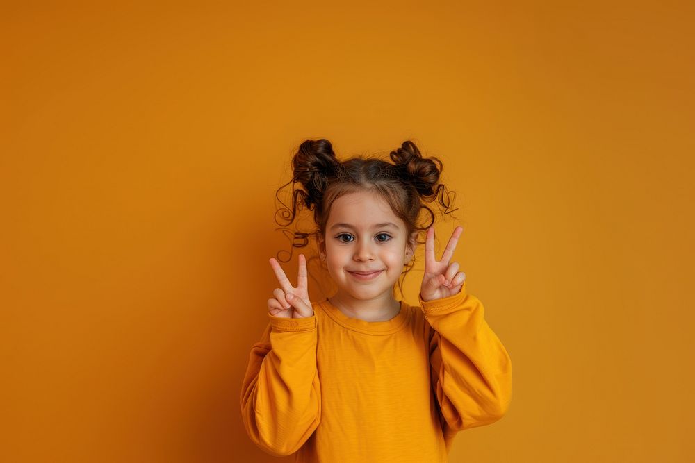 Photo of female kid with 2 finger pose portrait photography triumphant.