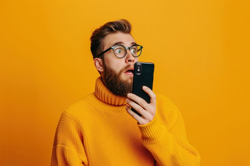 Photo of phone addicted man surprised clothing knitwear.