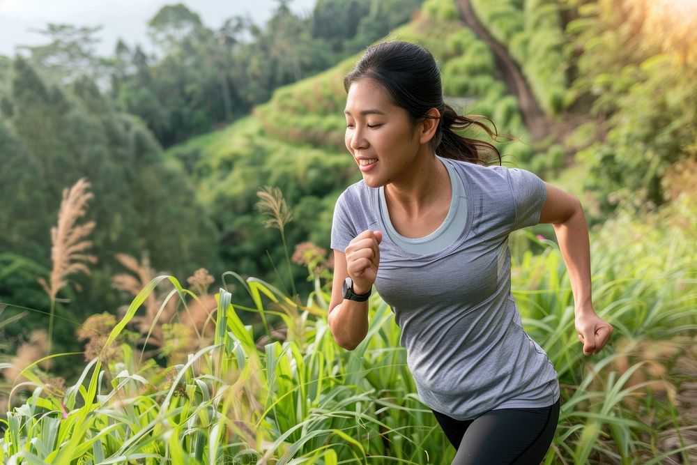Woman practicing endurance outdoors jogging running nature.