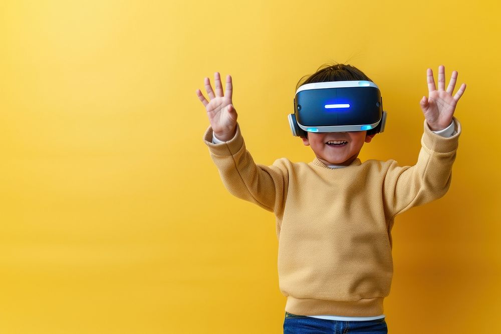 Boy wearing VR glasses technology happiness gesturing.