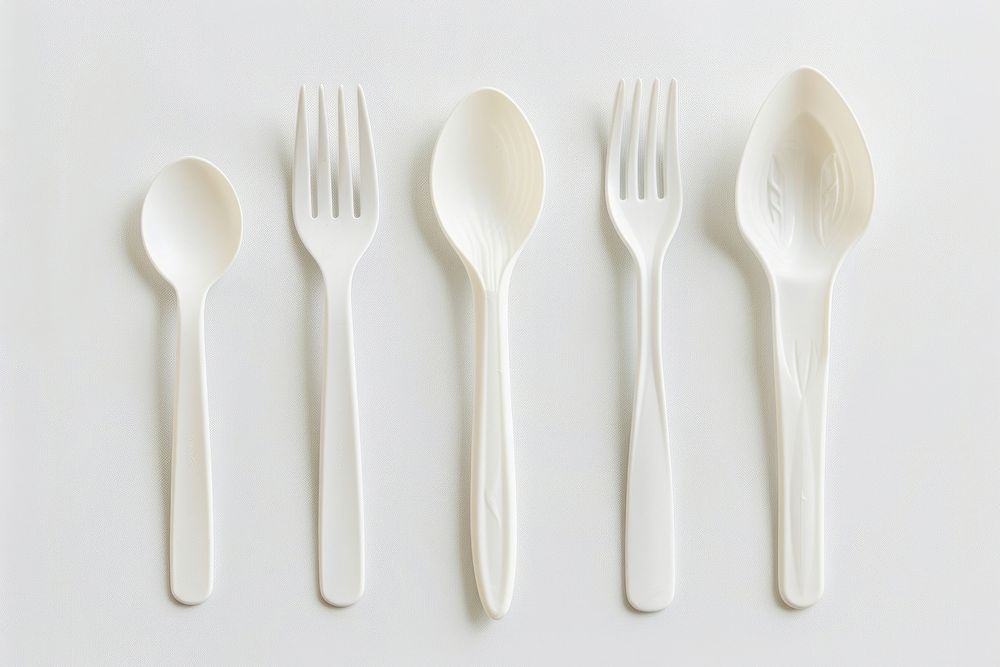 Brand new plastic utensils spoon white fork.