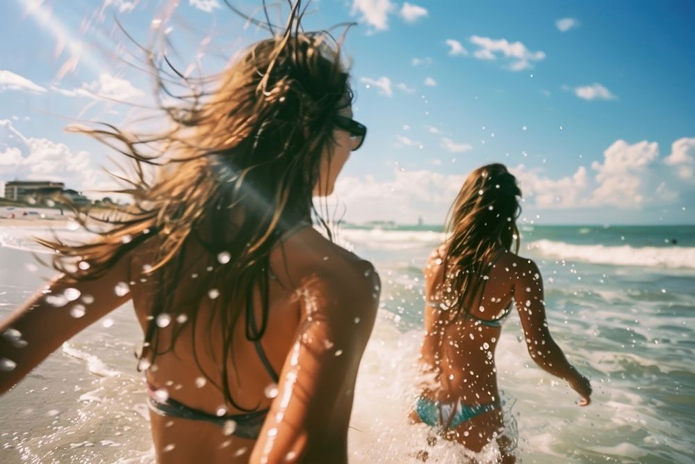 Women playing on the beach swimwear outdoors vacation.
