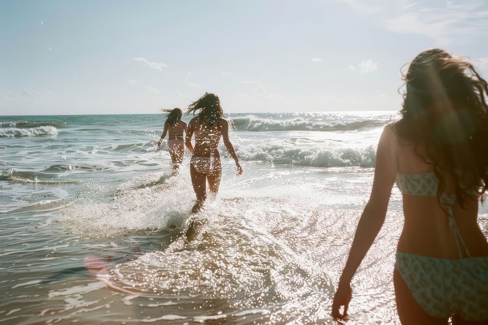 Womens playing on the beach swimwear outdoors vacation.