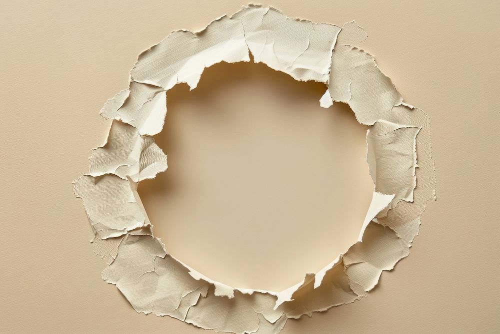Torn paper in circle shaped hole breaking damaged.