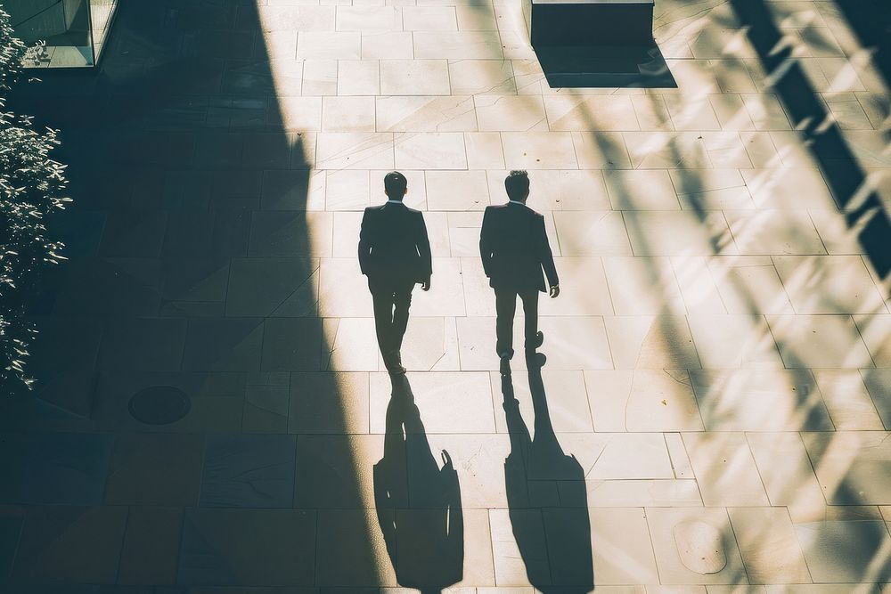 Two business man walking on the street silhouette pedestrian clothing.