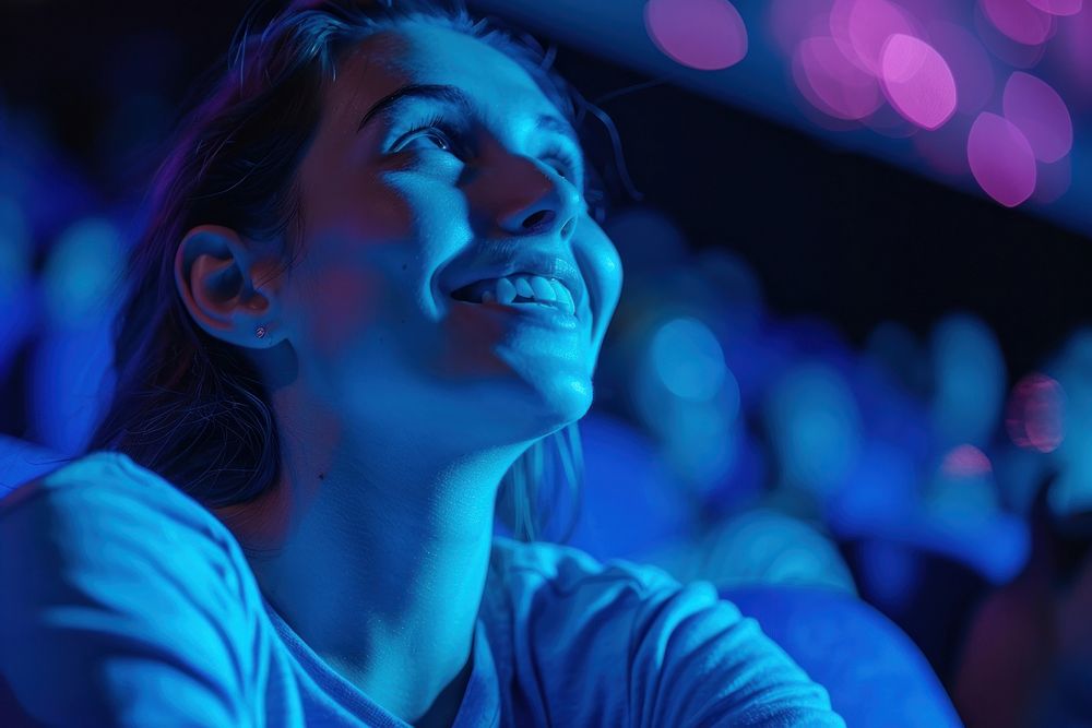 Young woman enjoying while watching movie smiling light adult.