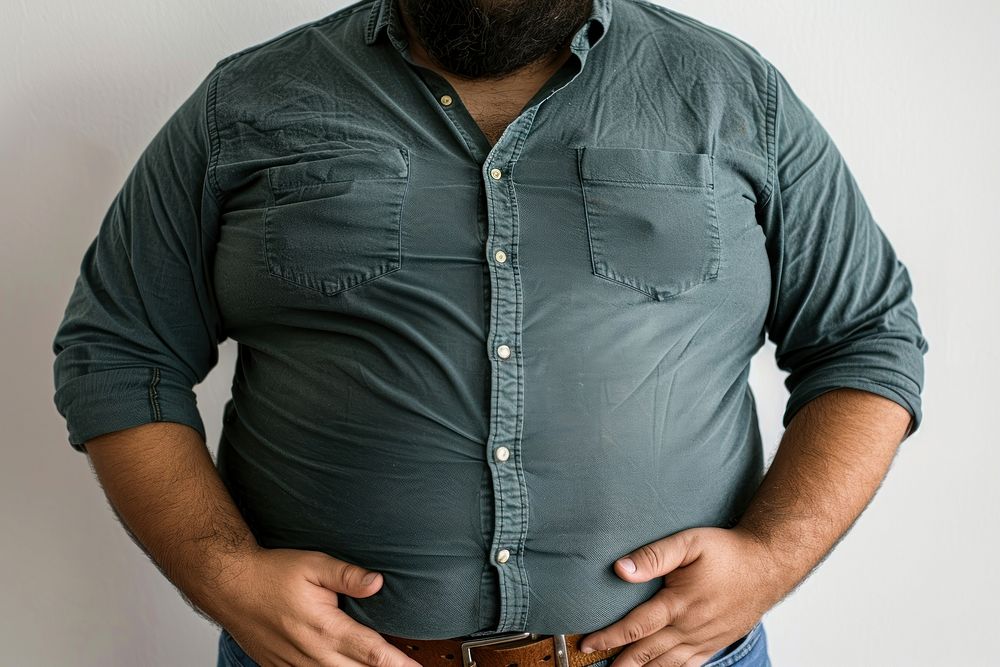 Tight shirt showing full belly sleeve denim jeans.