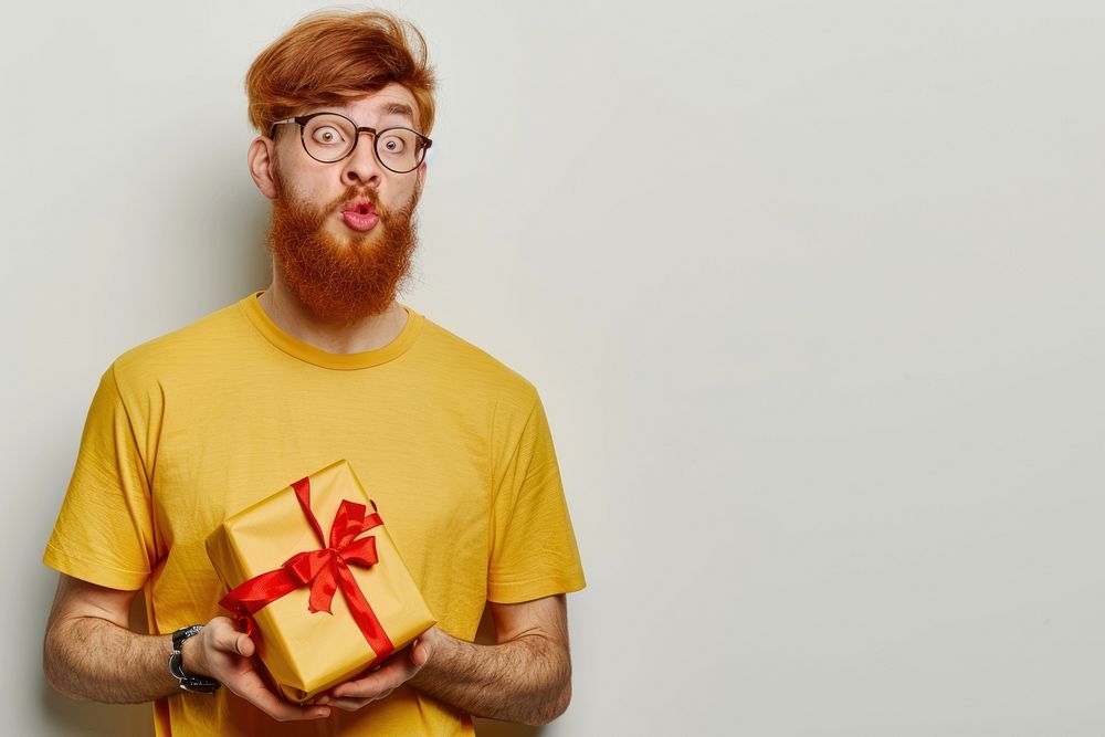 Man hold present box t-shirt yellow beard.