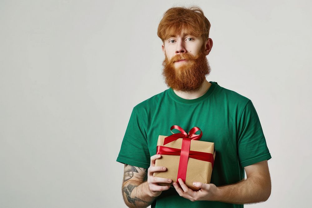 Man hold present box redhead t-shirt beard.