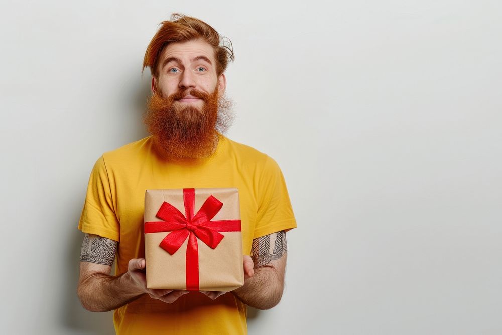 Man hold present box t-shirt yellow beard.