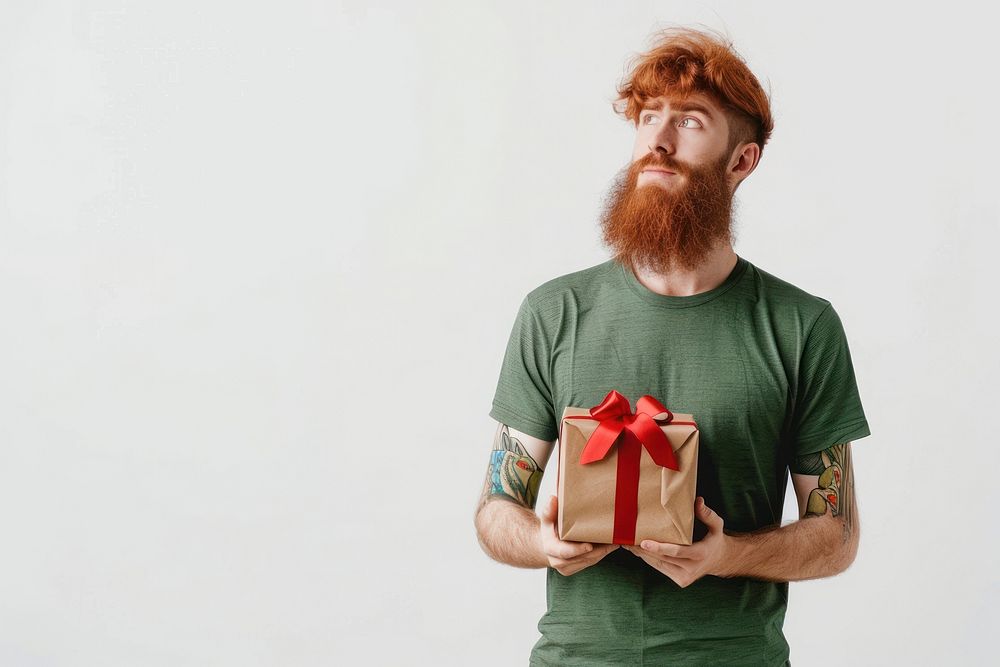 Man hold present box t-shirt redhead beard.