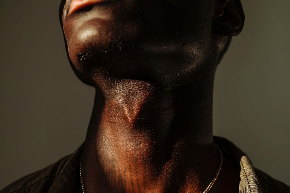 Neck of a skinny black boy model jewelry adult accessories.