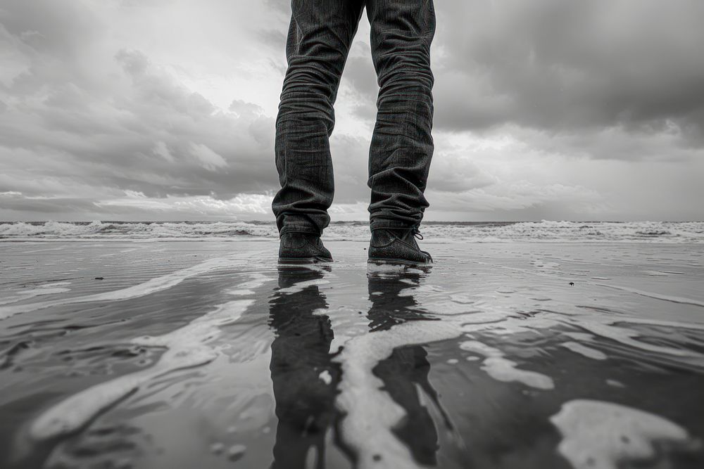 Man standing on beach sea outdoors footwear.
