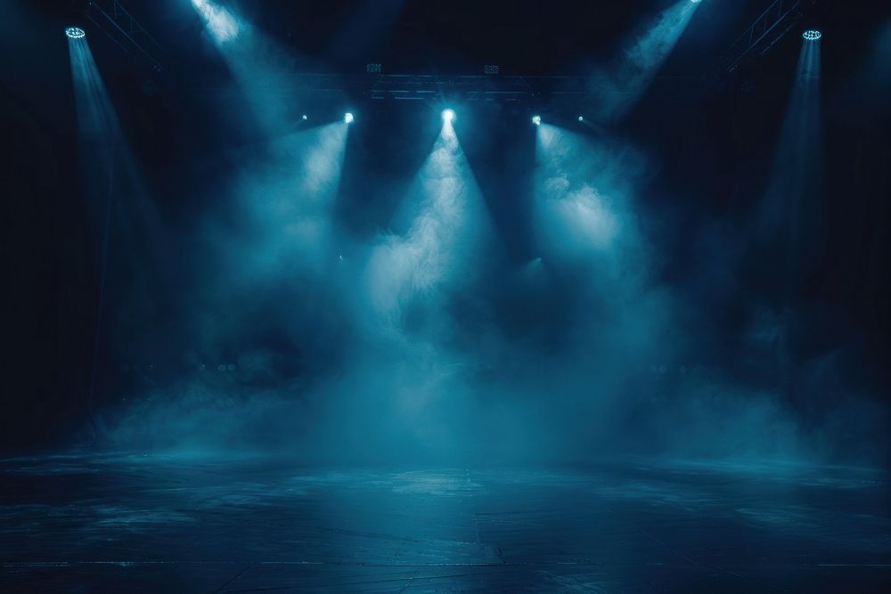 Illuminated stage with spotlights and smoke concert performer lighting.