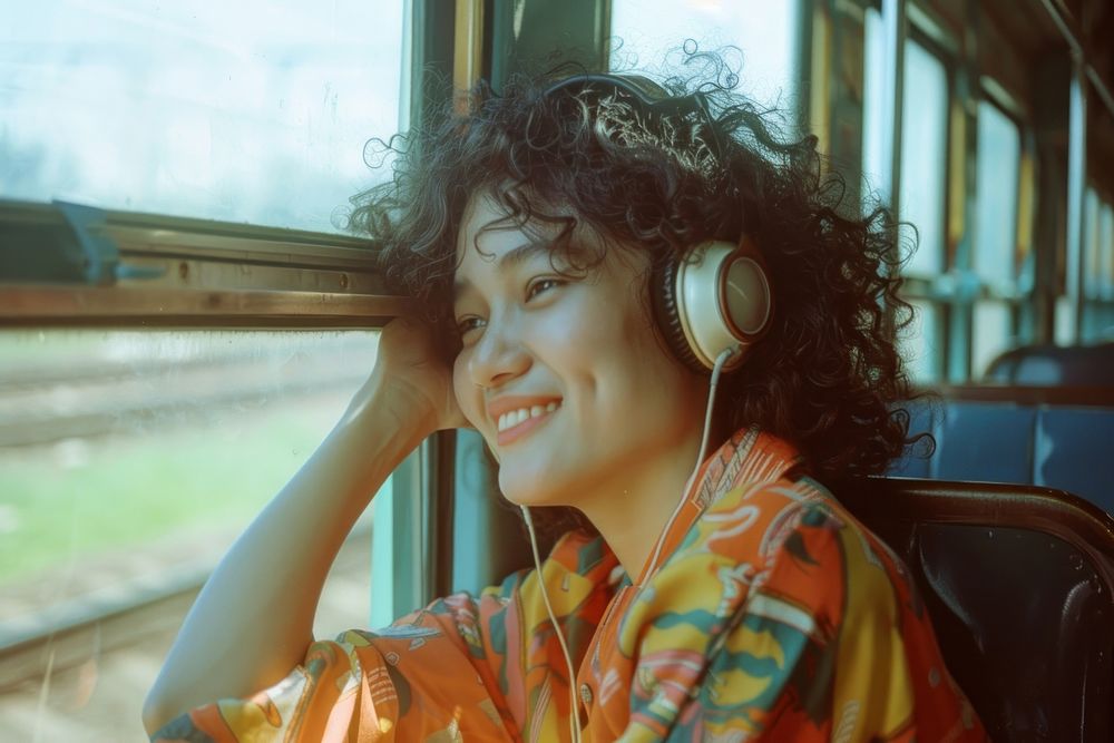Happy young Thai woman with curly hair wearing headphones happy electronics photography.