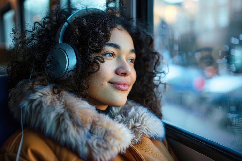 Happy young Thai woman with curly hair wearing headphones happy photography electronics.