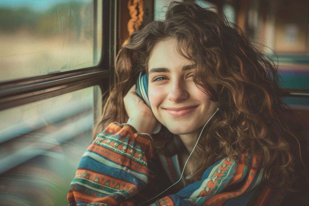 Happy young woman with curly hair wearing headphones happy photography portrait.