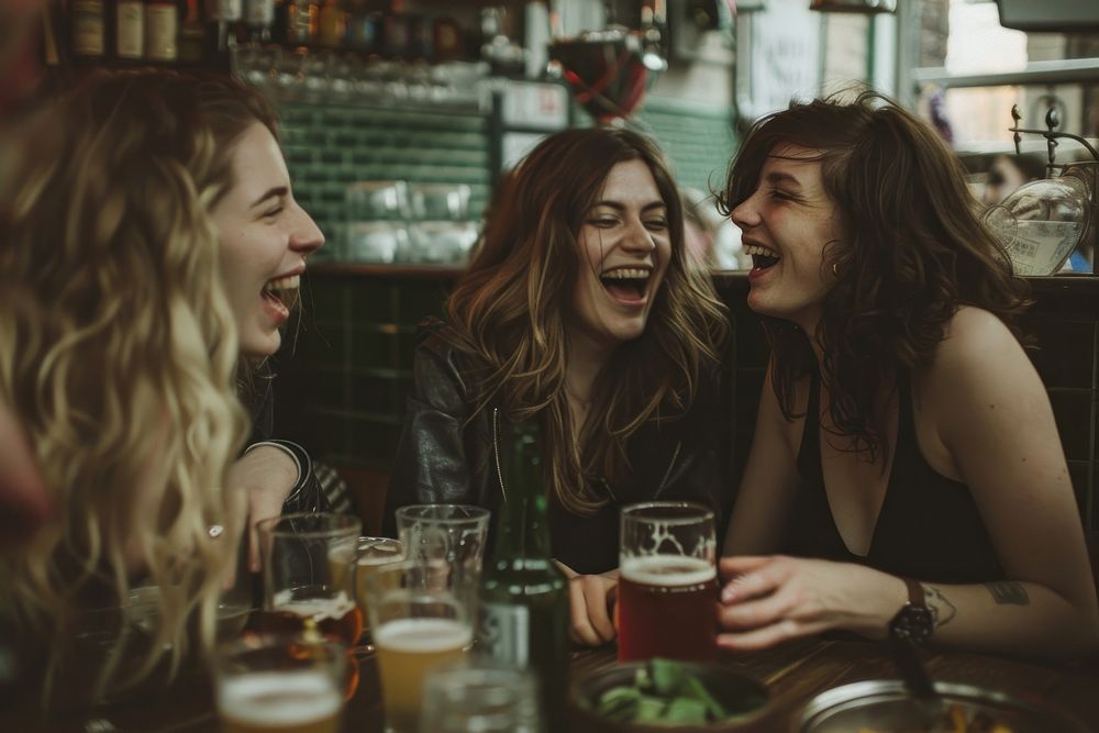 Happy Female Friends Having meal And Beer And Laughing laughing beer female.