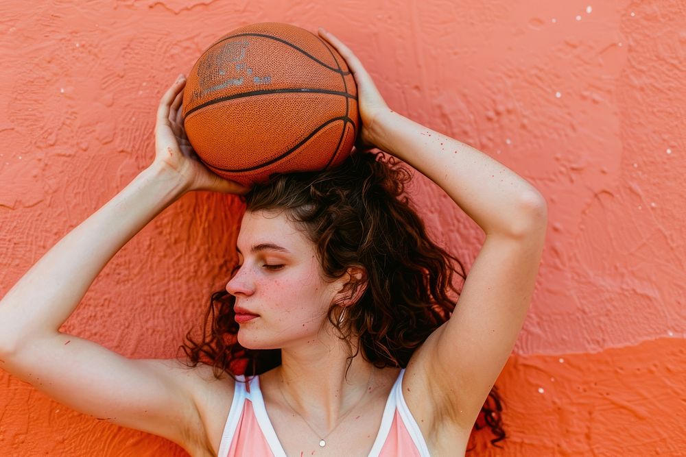 Woman playing sport indoor sports accessories basketball.